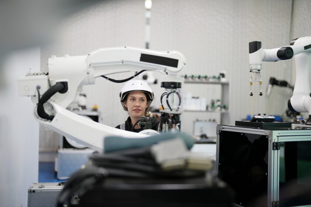 Robotic Arm engineer check on equipment in its with software of an Artificial Intelligence Computer